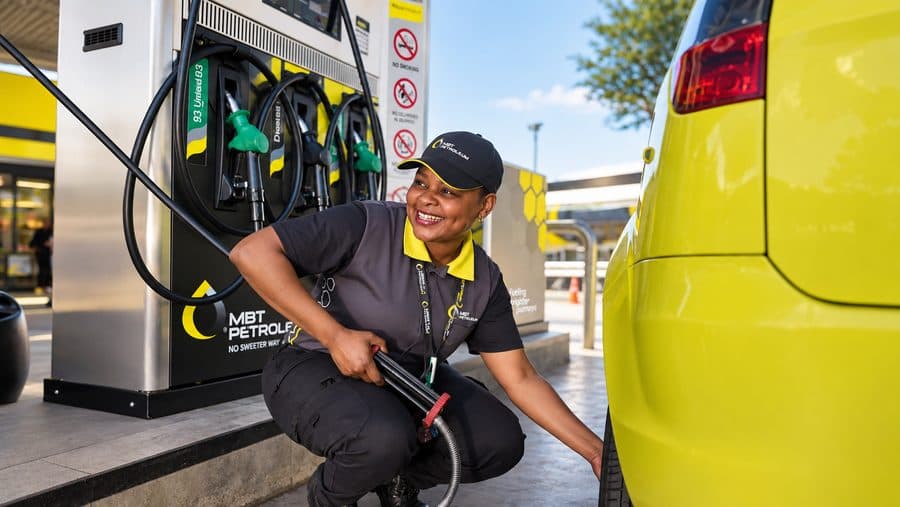 An MBT attendant refuelling a car on the forecourt