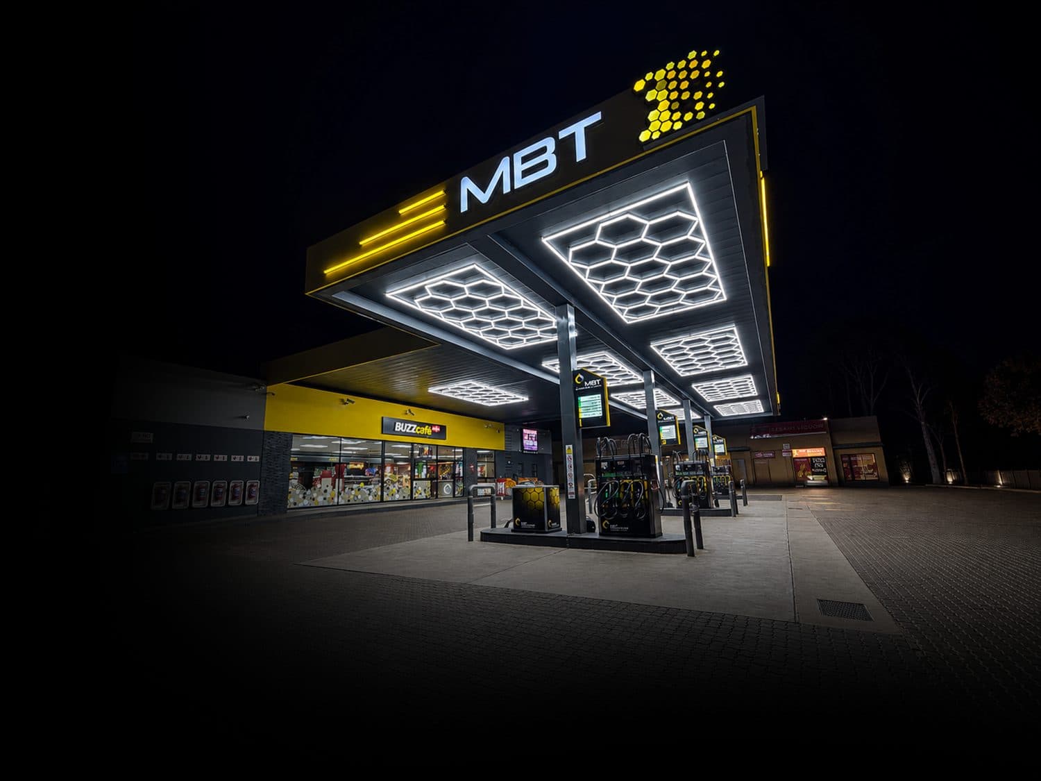 An MBT service station forecourt lit up at night